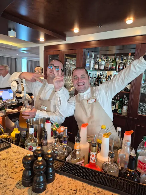 Vinny and Florin providing bar service aboard AmaLyra during an AmaWaterways Seine river cruise