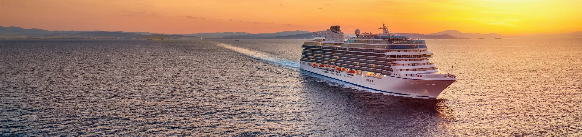 Ocean cruise ship sailing at sunset with Tripse